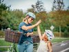 Un adulte et un élève à vélo font un high five